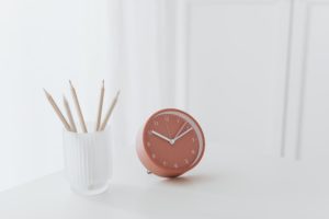 pink clock on white table